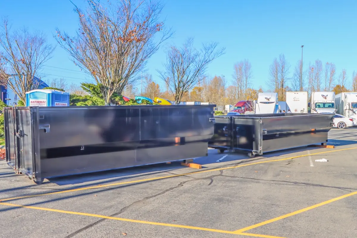 Professional dumpster rental service with roll-off container on residential driveway in Wasco